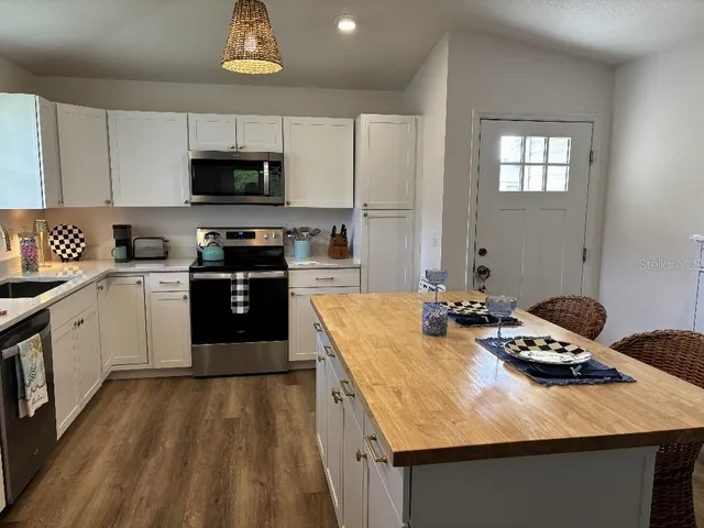 a kitchen with a stove a sink and a refrigerator