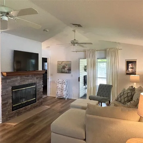a living room with furniture flat screen tv and a fireplace