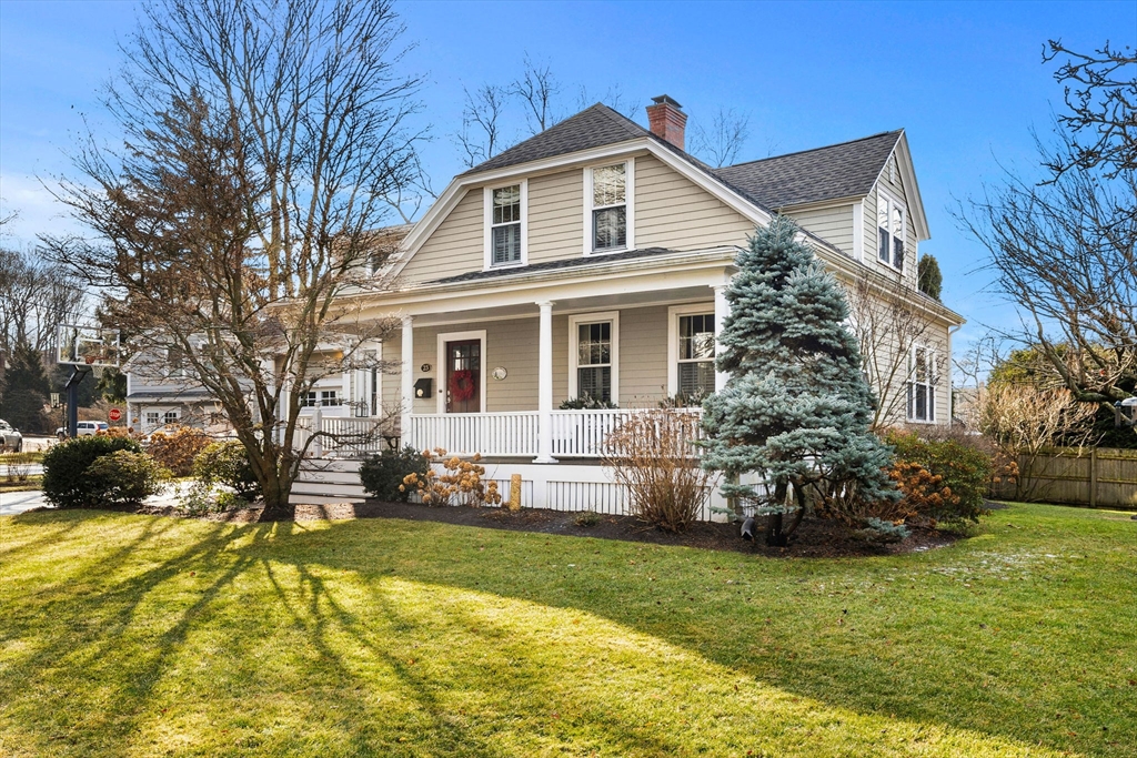 23 Wyman Road Marblehead, MA 01945 - Photo 1 of 42 a front view of a house with a yard table and chairs