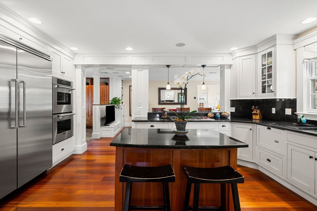 23 Wyman Road Marblehead, MA 01945 - Photo 15 of 42 a kitchen with stainless steel appliances granite countertop a stove a sink a refrigerator white cabinets with wooden floor