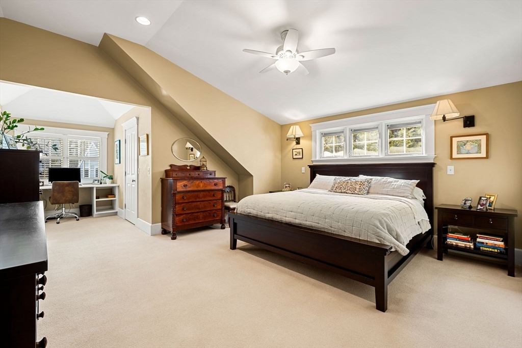23 Wyman Road Marblehead, MA 01945 - Photo 25 of 42 a spacious bedroom with a bed a couch and a chandelier