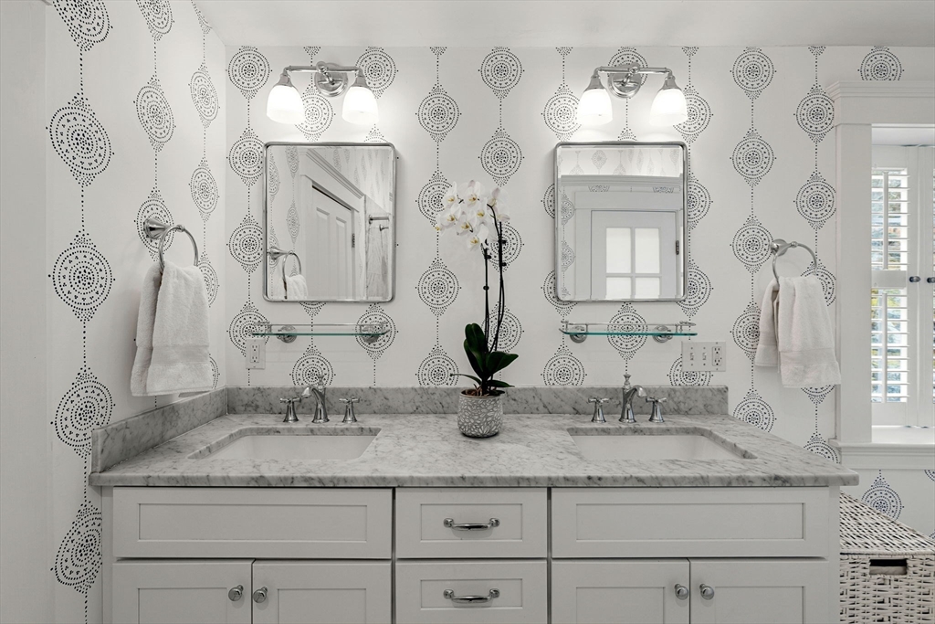 23 Wyman Road Marblehead, MA 01945 - Photo 34 of 42 a bathroom with a granite countertop sink and a mirror
