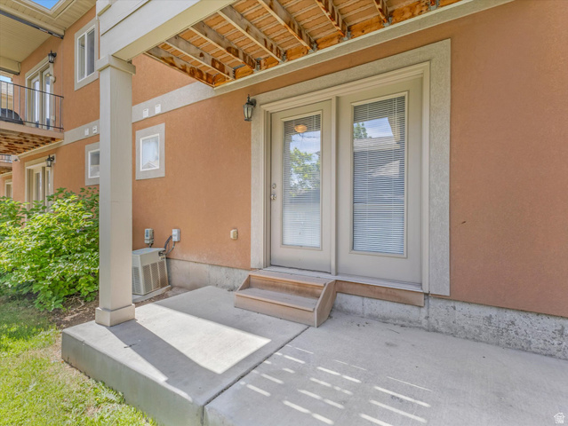 5038 West Red Shale Road Herriman, UT 84096 - Photo 15 of 16 Ground-level concrete patio featuring a support column and a double glass-panel door entry