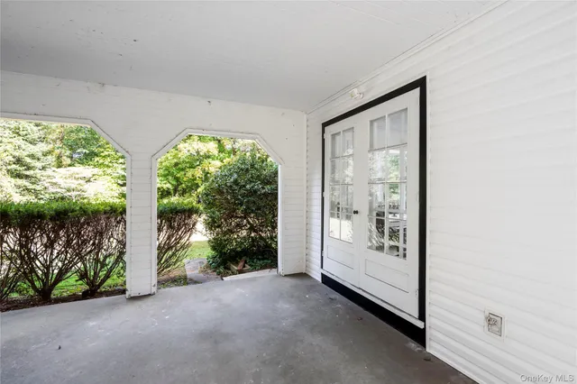an empty room with large windows