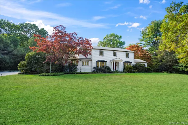 a view of a house with a yard and potted plants