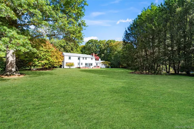 a backyard of a house with outdoor seating