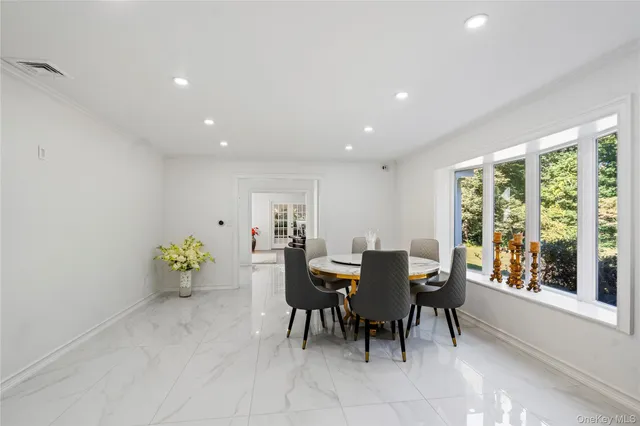 a view of a dining room with furniture and a potted plant