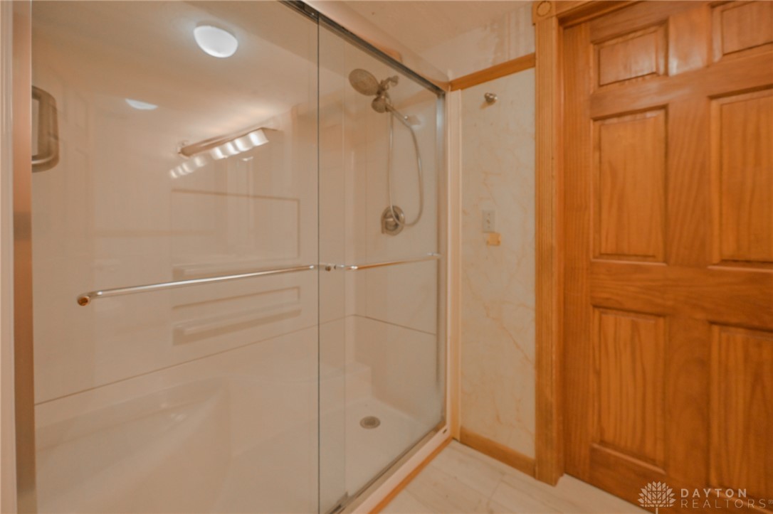 3057 Springfield Xenia Road Springfield, OH 45506 - Photo 17 of 37 This bathroom offers a glass-enclosed shower, providing a sleek and functional space.