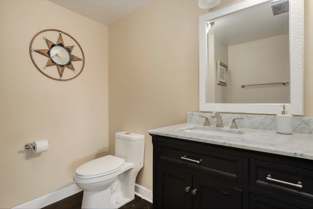 8369 West Kay Street Niles, IL 60714 - Photo 12 of 26 a bathroom with a granite countertop toilet sink and mirror