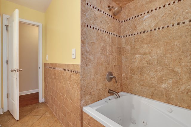 8369 West Kay Street Niles, IL 60714 - Photo 16 of 26 a bathroom with a sink and shower