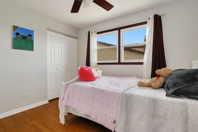 8369 West Kay Street Niles, IL 60714 - Photo 17 of 26 a bedroom with a bed and wooden floor