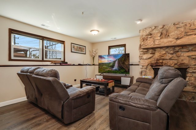 8369 West Kay Street Niles, IL 60714 - Photo 18 of 26 a living room with furniture and a flat screen tv