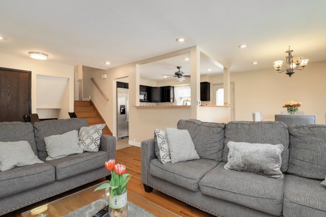 8369 West Kay Street Niles, IL 60714 - Photo 2 of 26 a living room with furniture and a chandelier