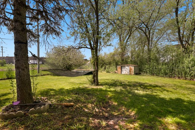 8369 West Kay Street Niles, IL 60714 - Photo 21 of 26 a yellow house with trees in front of it