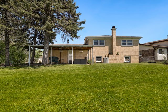 8369 West Kay Street Niles, IL 60714 - Photo 22 of 26 a front view of a house with a garden