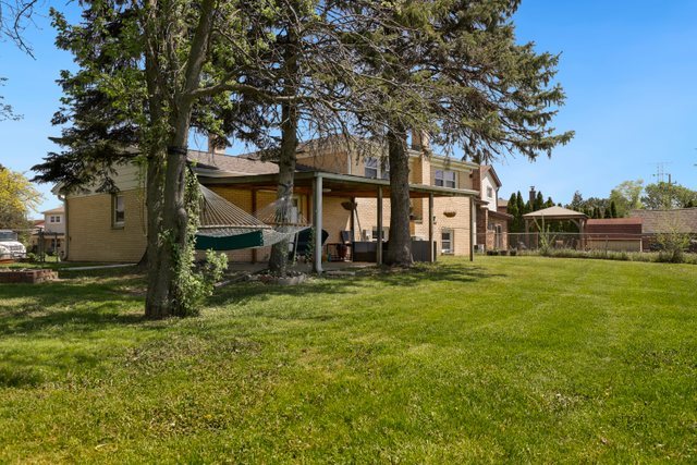 8369 West Kay Street Niles, IL 60714 - Photo 23 of 26 a front view of a house with a garden