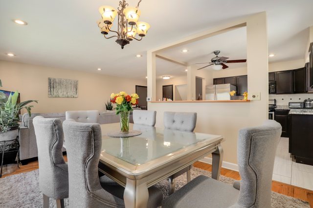 8369 West Kay Street Niles, IL 60714 - Photo 7 of 26 a view of a dining room with furniture and chandelier