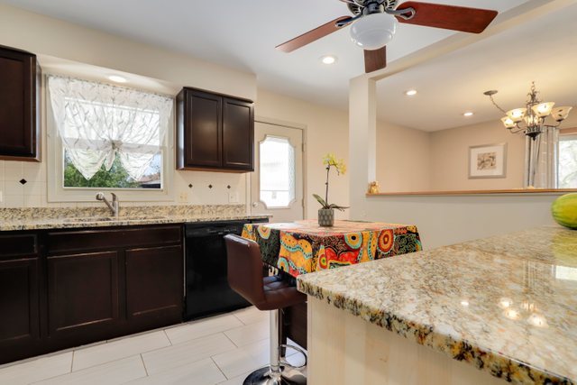 8369 West Kay Street Niles, IL 60714 - Photo 10 of 26 a kitchen with a sink a stove and cabinets