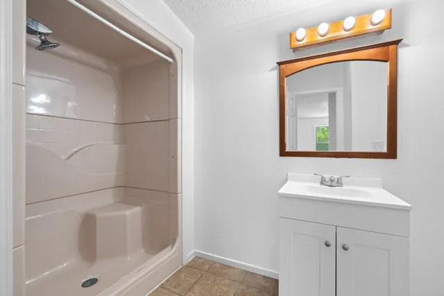 a bathroom with a sink a vanity and a mirror