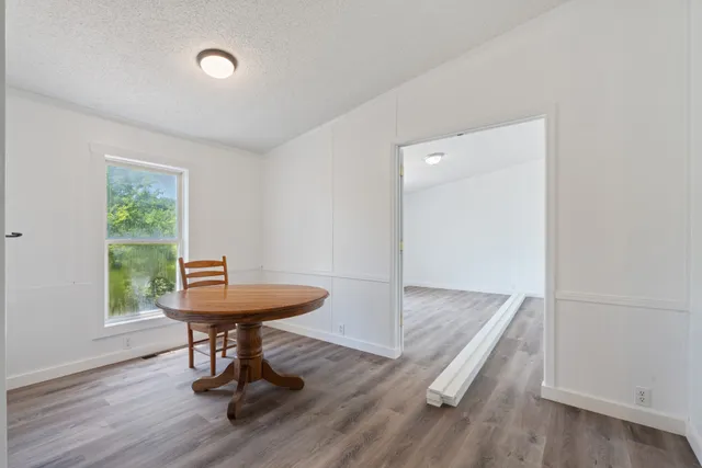 a view of a room with a table and chairs