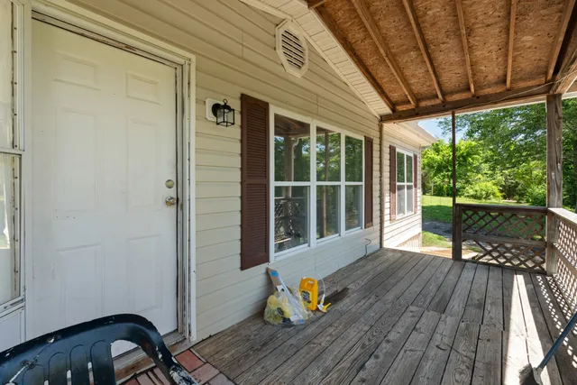 a balcony with wooden floor and outdoor space
