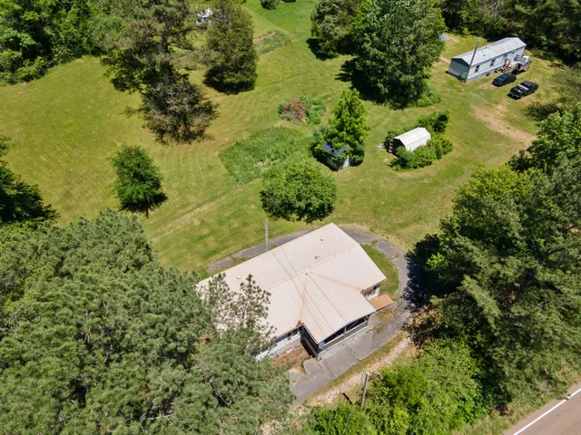 an aerial view of a house with a yard and lake view