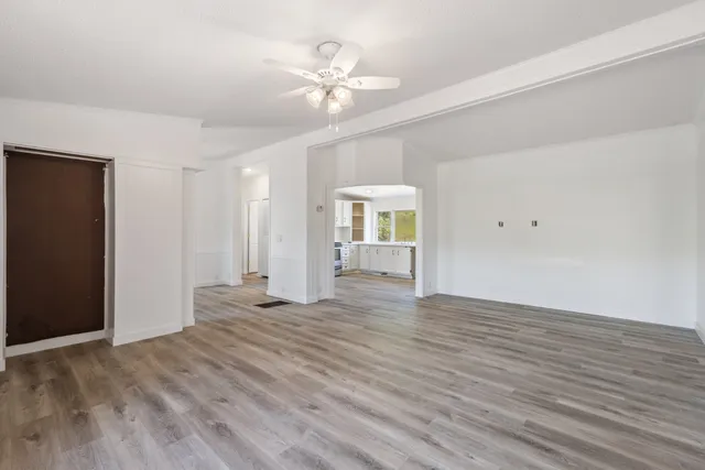 a view of an empty room with wooden floor