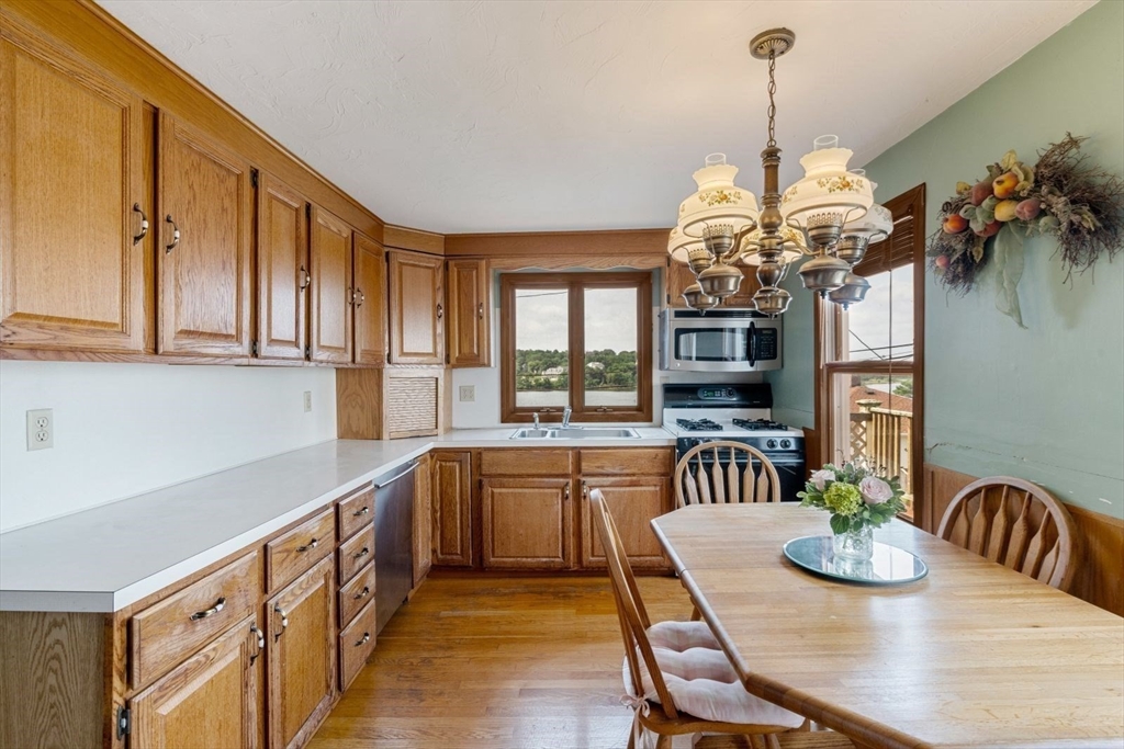 49 Summit Avenue Hull, MA 02045 - Photo 17 of 29 a view of a dining room with furniture a chandelier and wooden floor