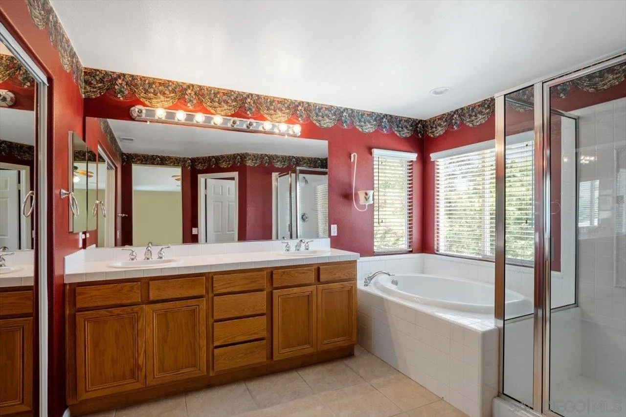 2195 Stone Castle Fallbrook, CA 92028 - Photo 25 of 37 a bathroom with a tub sink and mirror