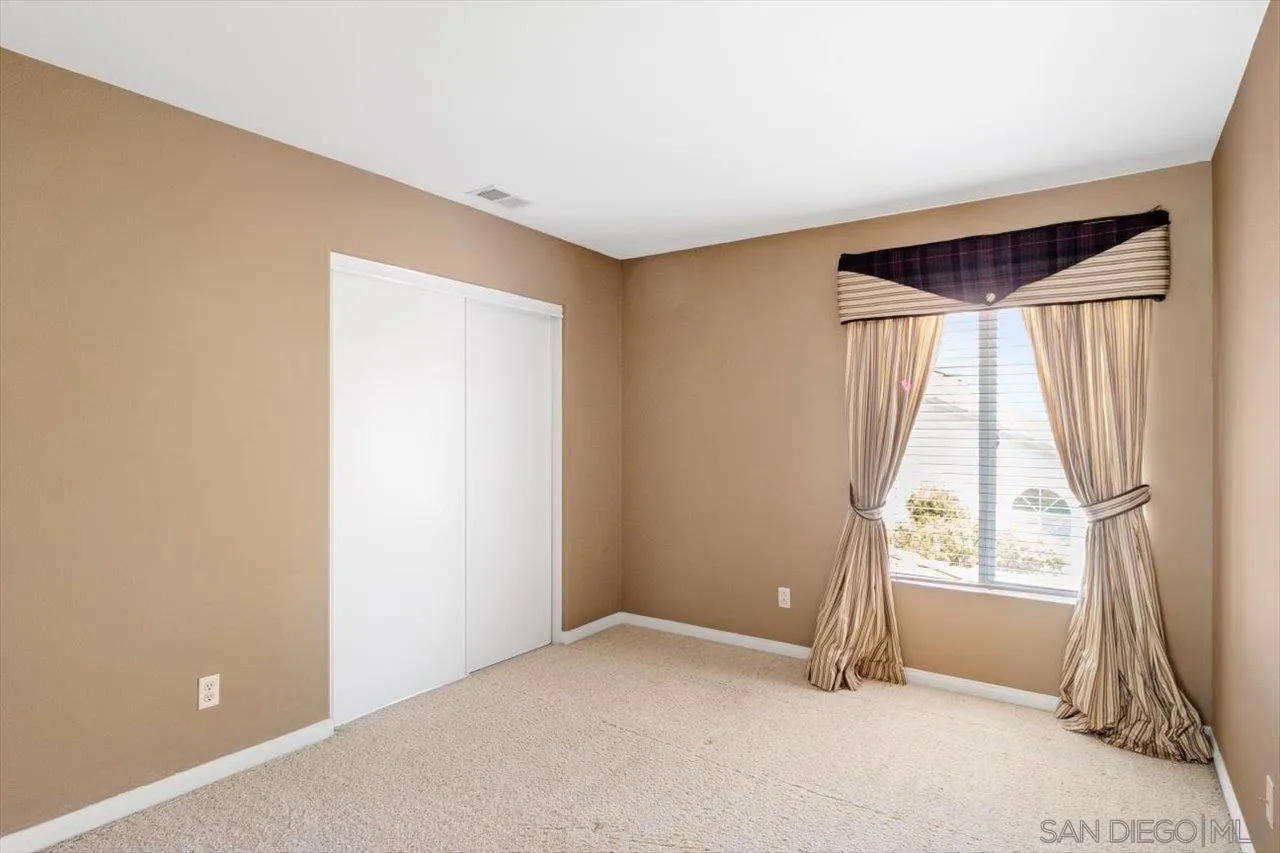 2195 Stone Castle Fallbrook, CA 92028 - Photo 26 of 37 an empty room with wooden floor and a window