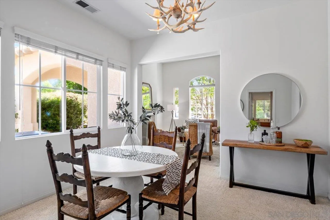 2195 Stone Castle Fallbrook, CA 92028 - Photo 7 of 37 a view of a dining room with furniture a chandelier and wooden floor