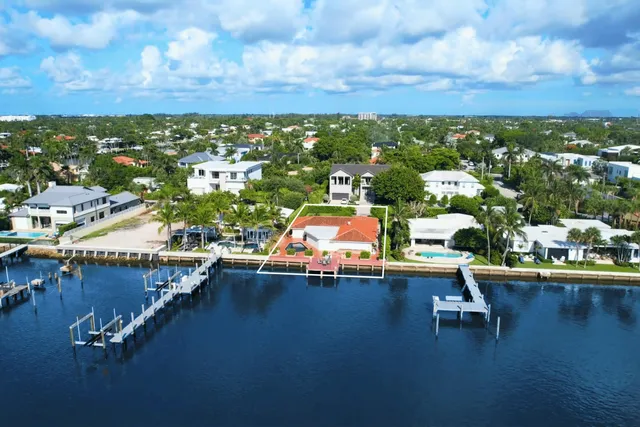 an aerial view of a swimming pool with outdoor seating