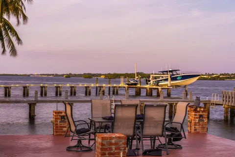 a view of a lake with a table and chairs