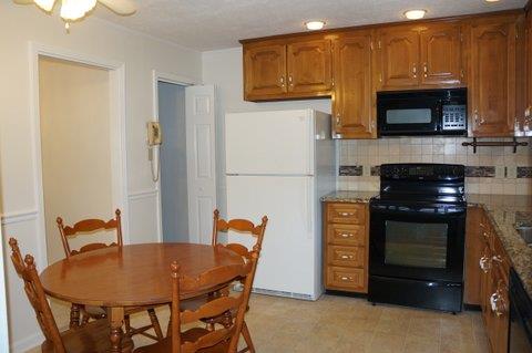 2117 Layton Road Clarksville, TN 37043 - Photo 11 of 20 This view of the Kitchen shows the eat in area and the door that leads to the finished basement. Kitchen appliance's to stay include the Refrigerator, Smooth top Range, Microwave and Dishwasher.