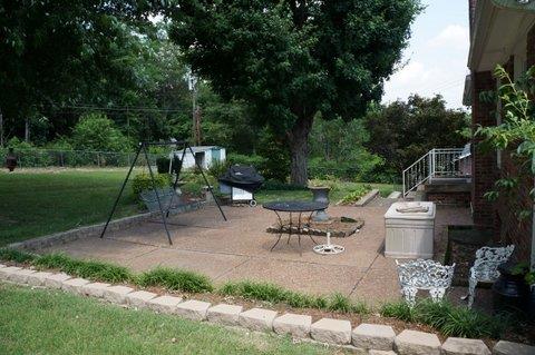 2117 Layton Road Clarksville, TN 37043 - Photo 17 of 20 Let's head out to a very large patio in the backyard. This homeowner loved to flower garden and you can sure tell by all the landscaping. Big beautiful trees adorn this backyard.