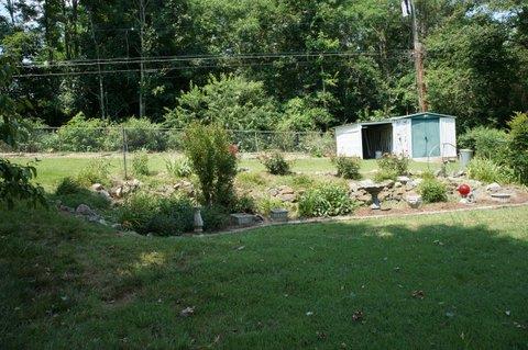 2117 Layton Road Clarksville, TN 37043 - Photo 20 of 20 Yet again another flower garden with a large vegetable garden space behind that! Backyard is fully fenced. Storage buildings stay.