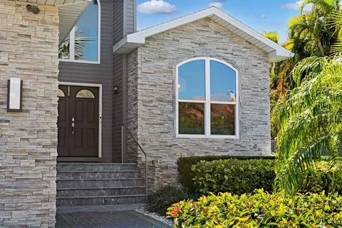a kitchen with stainless steel appliances kitchen island granite countertop a refrigerator and a stove top oven