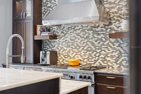 a kitchen with stainless steel appliances a refrigerator and cabinets