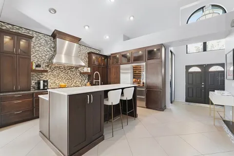 a kitchen with a refrigerator and more cabinets