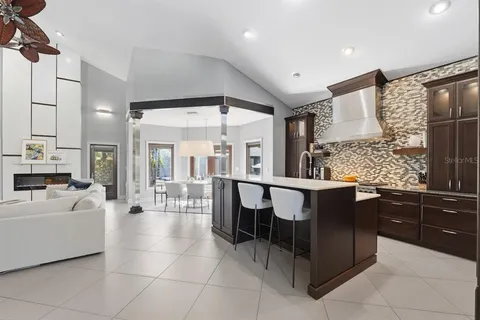 a dining room with furniture a chandelier and fireplace