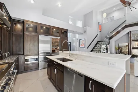 a dining room with wooden floor a glass table and chairs