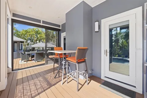 a bedroom with a bed a dresser and book shelfs