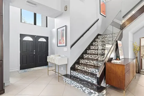 a living room with a flat screen tv and floor to ceiling window