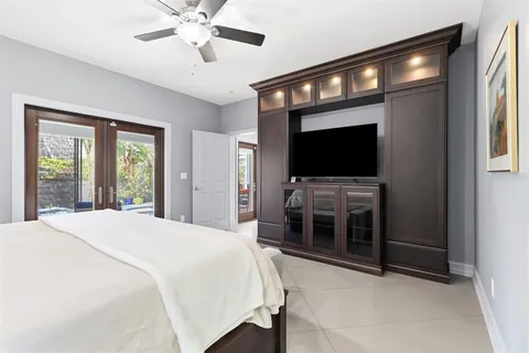 a green field with some trees in front of it