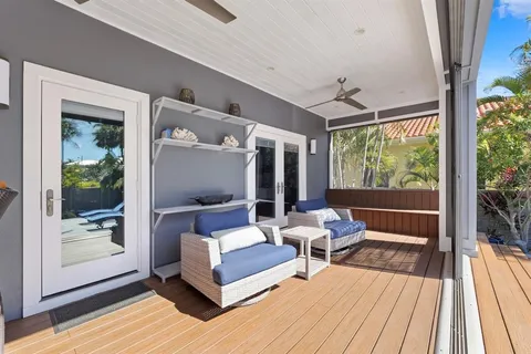 a view of a house with swimming pool and sitting area