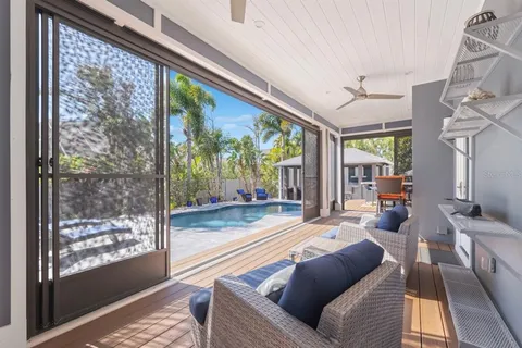 a view of a house with swimming pool and sitting area