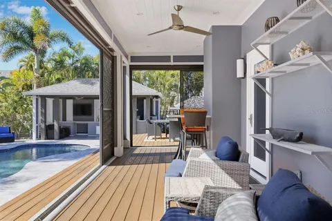 a view of a swimming pool with lawn chairs under an umbrella