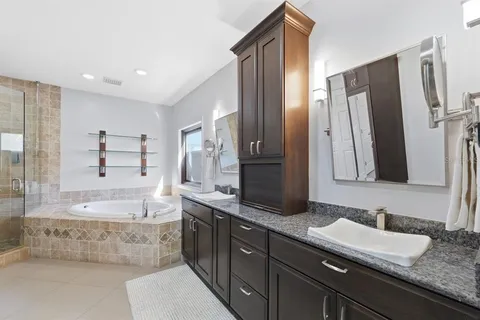 a view of a house with swimming pool and sitting area