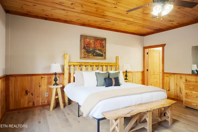 a bedroom with a bed and a chandelier