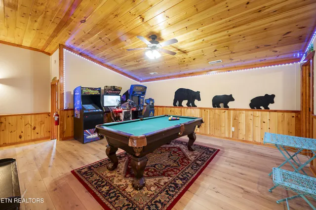 a room with lots of table tennis pool table and a rug